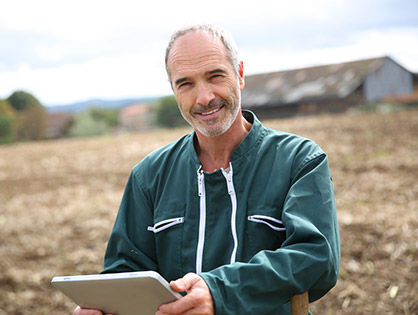 Farmer in field on tablet